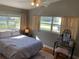 Bright bedroom with abundant natural light, a cozy sleeping area, and a dedicated vanity space for getting ready at 217 Wilmer Ave, Orlando, FL 32811