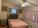 Cozy bedroom with ceiling fan, stylish headboard, and colorful parrot wall art at 217 Wilmer Ave, Orlando, FL 32811