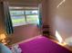 Bedroom showcasing a colorful bed and a glass side table at 217 Wilmer Ave, Orlando, FL 32811
