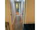Neutral hallway featuring a decorative rug and access to other rooms at 217 Wilmer Ave, Orlando, FL 32811