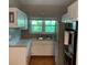 Compact kitchen with stainless steel appliances and white cabinetry at 217 Wilmer Ave, Orlando, FL 32811