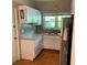 Compact kitchen with stainless steel appliances and white cabinetry at 217 Wilmer Ave, Orlando, FL 32811