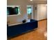 Living room with tiled floor, blue sofa, and built in television area at 217 Wilmer Ave, Orlando, FL 32811