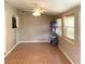 Sunlit living room features tiled floors, ceiling fan, and bright windows at 217 Wilmer Ave, Orlando, FL 32811