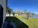 Backyard featuring a well-maintained lawn, a fence and a beautiful view of a lake at 235 Tuscany Pointe Ave, Orlando, FL 32807