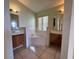 Bathroom featuring a corner tub, double sinks, and ample counter space at 235 Tuscany Pointe Ave, Orlando, FL 32807