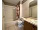 Cozy bathroom features a shower-tub combo, tile flooring, and a single sink vanity with mirror at 235 Tuscany Pointe Ave, Orlando, FL 32807