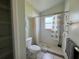 Full bathroom with a walk-in shower, toilet, and a small window at 235 Tuscany Pointe Ave, Orlando, FL 32807