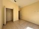 Vacant bedroom with tile flooring, a closet, and a window offers an airy space for comfort at 235 Tuscany Pointe Ave, Orlando, FL 32807