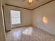 Empty bedroom showcasing tile floors, a window, and ceiling fan, ready for personalization at 235 Tuscany Pointe Ave, Orlando, FL 32807