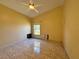 Bedroom with tile floor, ceiling fan, and a window providing natural light at 235 Tuscany Pointe Ave, Orlando, FL 32807