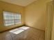 Bright bedroom with tiled floor, a window with blinds, and neutral wall color at 235 Tuscany Pointe Ave, Orlando, FL 32807