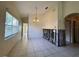 View of the dining room and the open frame wall; featuring tile flooring, a decorative light, and good sunlight at 235 Tuscany Pointe Ave, Orlando, FL 32807