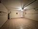 Spacious two-car garage with tiled floors, a ceiling fan, storage racks and a water heater at 235 Tuscany Pointe Ave, Orlando, FL 32807