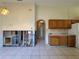 Kitchen area with wooden cabinets and countertop space, and an open frame of removed drywall for remodeling at 235 Tuscany Pointe Ave, Orlando, FL 32807