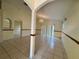 Spacious living room featuring tile floors and a decorative chandelier at 235 Tuscany Pointe Ave, Orlando, FL 32807