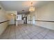 Open-concept living area with tile floors, decorative lighting, and access to the kitchen at 235 Tuscany Pointe Ave, Orlando, FL 32807