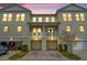 Attractive two-story townhome at dusk featuring a private balcony and attached two-car garage at 239 Long Iron Loop # 239, Kissimmee, FL 34747