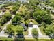 An aerial view shows the home with a long drive leading to a detached garage and plenty of yard space at 2431 Narcissus Ave, Sanford, FL 32771