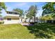 Spacious backyard features a brick patio, a charming house, and a white privacy fence at 2431 Narcissus Ave, Sanford, FL 32771