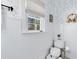 Bathroom features floral wallpaper, white wainscotting, and natural light from the window at 2431 Narcissus Ave, Sanford, FL 32771