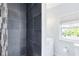 Modern tiled shower and a vanity with a window providing natural light at 2431 Narcissus Ave, Sanford, FL 32771
