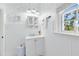 Charming bathroom with beadboard paneling, floral wallpaper, and ample natural light at 2431 Narcissus Ave, Sanford, FL 32771