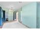 Spacious bedroom with light-green walls, an adjacent bathroom, hardwood floors, and natural light at 2431 Narcissus Ave, Sanford, FL 32771