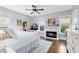 Primary bedroom features a fireplace, hardwood floors, natural lighting, and painted in a neutral color palette at 2431 Narcissus Ave, Sanford, FL 32771