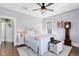 Bedroom features a bed with white linens, a ceiling fan, and hardwood floors at 2431 Narcissus Ave, Sanford, FL 32771