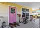 Inviting front porch features a pink door with a floral wreath and comfortable seating at 2431 Narcissus Ave, Sanford, FL 32771