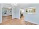 Spacious living room with light wood floors seamlessly connected to the kitchen at 2431 Narcissus Ave, Sanford, FL 32771