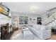Bright living room with large sofa, fireplace, hardwood floors and staircase at 2431 Narcissus Ave, Sanford, FL 32771