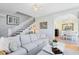 Cozy living room with staircase, hardwood floors, comfortable sofa, and view to dining room at 2431 Narcissus Ave, Sanford, FL 32771