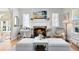 Bright living room featuring a cozy fireplace, mantle with TV, and tasteful décor at 2431 Narcissus Ave, Sanford, FL 32771