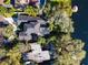 Aerial view of property showcasing the house, pool, lush landscaping, and lakefront setting at 254 Sylvan Blvd, Winter Park, FL 32789