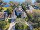Panoramic aerial view of the property showcasing its expansive layout, lush landscaping, and proximity to a lake at 254 Sylvan Blvd, Winter Park, FL 32789