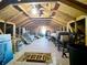 Unfinished attic showing wooden rafters, some stored items, and a ladder to the lower level at 254 Sylvan Blvd, Winter Park, FL 32789