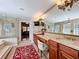 Luxurious bathroom featuring double vanity, large mirror, chandelier, and access to a glass-enclosed shower at 254 Sylvan Blvd, Winter Park, FL 32789