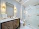 Elegant bathroom featuring a glass walk-in shower, modern vanity, and stylish patterned wallpaper at 254 Sylvan Blvd, Winter Park, FL 32789
