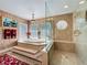 Bright bathroom featuring a soaking tub with marble steps, glass-enclosed shower, and stylish fixtures at 254 Sylvan Blvd, Winter Park, FL 32789