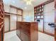 Spacious walk-in closet featuring custom shelving and an island at 254 Sylvan Blvd, Winter Park, FL 32789