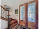 Inviting home entrance showcasing a wooden staircase, decorative glass door, and stylish rug, perfect for welcoming guests at 254 Sylvan Blvd, Winter Park, FL 32789