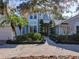 Beautiful two-story home with lush landscaping, mature trees, and a brick paver walkway at 254 Sylvan Blvd, Winter Park, FL 32789