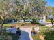 View of the home's front yard with mature trees, shrubs, and a paver walkway at 254 Sylvan Blvd, Winter Park, FL 32789