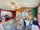 Cozy living room featuring a home office setup, comfortable seating, and a decorative area rug at 254 Sylvan Blvd, Winter Park, FL 32789