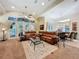 Spacious living room featuring a large sectional sofa, glass coffee table, and access to an outdoor patio at 254 Sylvan Blvd, Winter Park, FL 32789