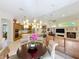 Open-concept living space with a dining area, kitchen, and fireplace, perfect for entertaining at 254 Sylvan Blvd, Winter Park, FL 32789