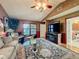 Comfortable living room with TV, wainscoting, and view into kitchen at 254 Sylvan Blvd, Winter Park, FL 32789