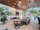 Bright living room with a wooden ceiling, brick fireplace, large windows with water views, and comfortable seating at 254 Sylvan Blvd, Winter Park, FL 32789